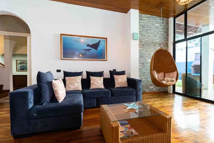 Navy sectional and hanging wicker chair at GPS Villa, Puerto Ayora
