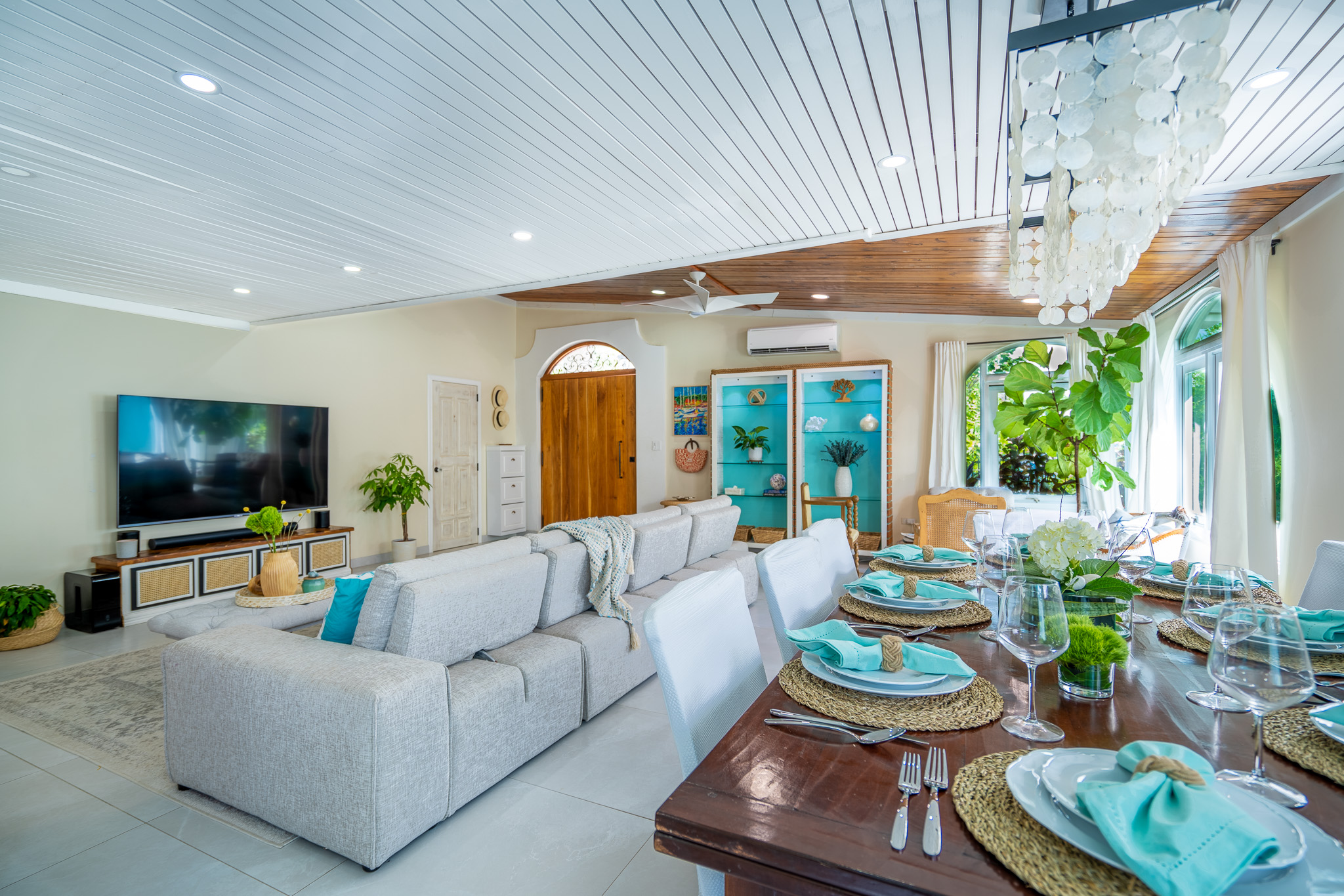 Downstairs dining table for 12 at Villa Coral, white slipcovered chairs